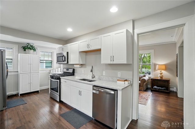 27 Spirea Dr, Oakwood, OH 45419 - kitchen featuring appliances with stainless steel finishes, a sink, white cabinetry, light stone countertops, and baseboard heating