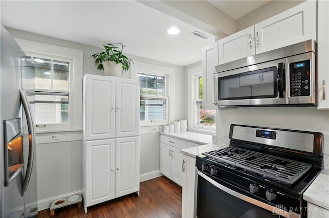 27 Spirea Dr, Oakwood, OH 45419 - kitchen with stainless steel appliances, dark wood-type flooring, white cabinets, baseboards, and light stone counters