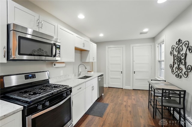 27 Spirea Dr, Oakwood, OH 45419 - kitchen with appliances with stainless steel finishes, a sink, dark wood finished floors, white cabinets, and light stone counters