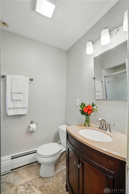 27 Spirea Dr, Oakwood, OH 45419 - bathroom with baseboard heating, vanity, toilet, a shower with door, and stone finish floors