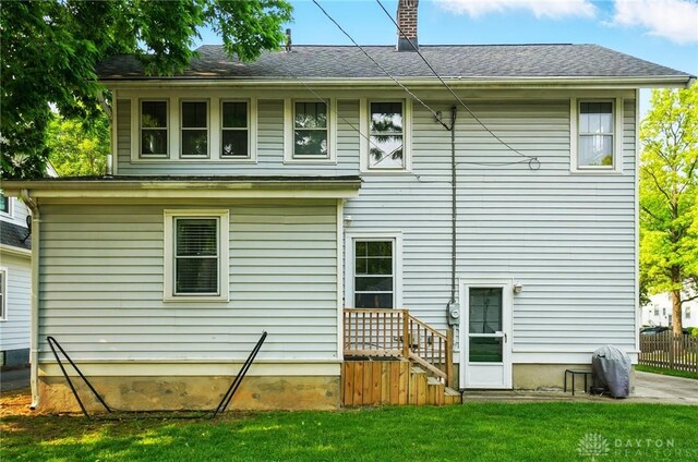 27 Spirea Dr, Oakwood, OH 45419 - back of property with a chimney and roof with shingles