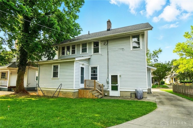 27 Spirea Dr, Oakwood, OH 45419 - rear view of property featuring a chimney and concrete driveway