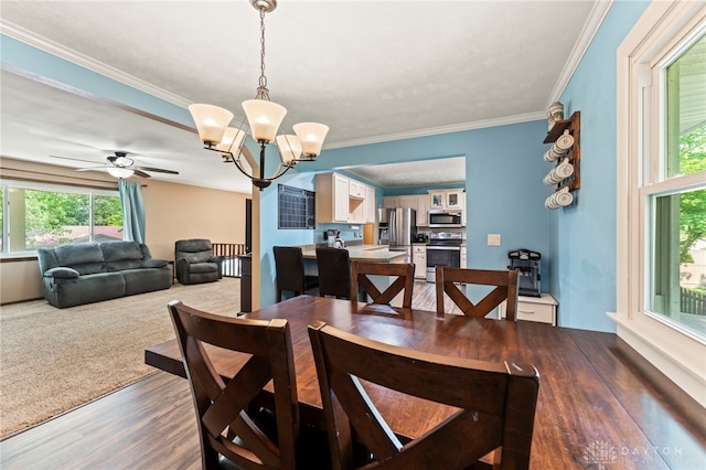 340 Marsha Jeanne Way, Dayton, OH 45458 - dining space with a chandelier, wood finished floors, crown molding, and a ceiling fan