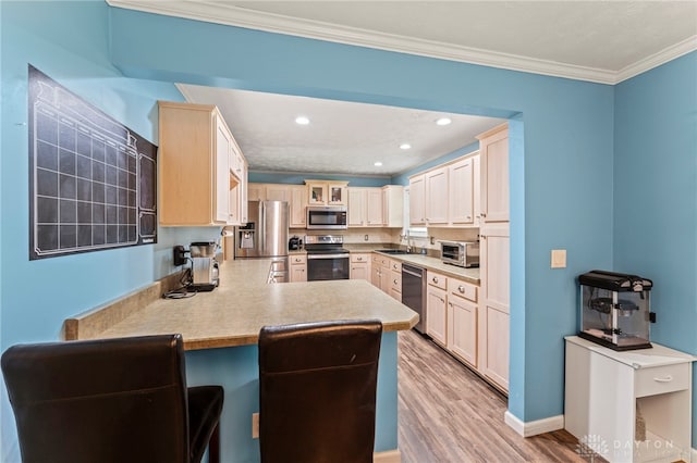 340 Marsha Jeanne Way, Dayton, OH 45458 - kitchen featuring stainless steel appliances, a peninsula, light wood-style floors, crown molding, and a breakfast bar area