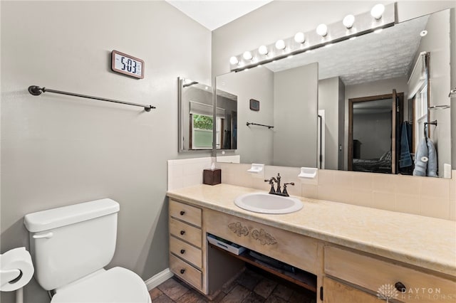 340 Marsha Jeanne Way, Dayton, OH 45458 - ensuite bathroom featuring toilet, vanity, baseboards, and backsplash