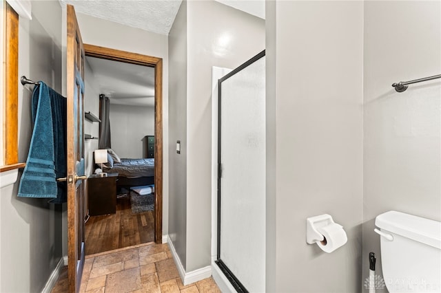 340 Marsha Jeanne Way, Dayton, OH 45458 - full bathroom with stone tile floors, a stall shower, toilet, ensuite bathroom, and baseboards