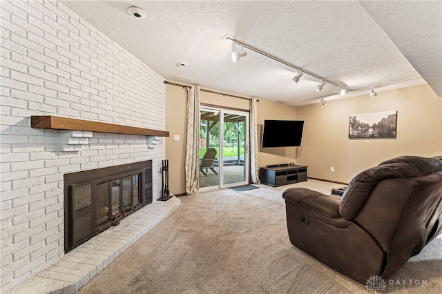 340 Marsha Jeanne Way, Dayton, OH 45458 - carpeted living area with a brick fireplace, track lighting, a textured ceiling, and baseboards