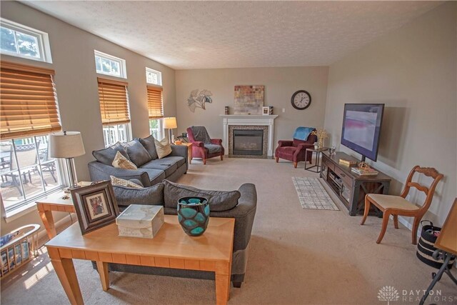 4560 James Madison Trl, Kettering, OH 45440 - living room featuring carpet, a fireplace with flush hearth, and a textured ceiling