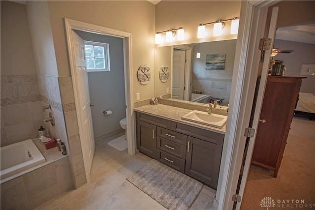 4560 James Madison Trl, Kettering, OH 45440 - full bath with a garden tub, toilet, vanity, ceiling fan, and tile patterned floors