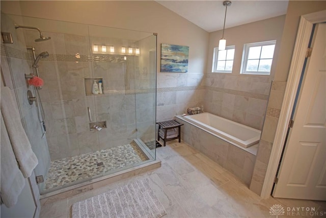 4560 James Madison Trl, Kettering, OH 45440 - bathroom featuring a bath, a shower stall, lofted ceiling, and tile walls