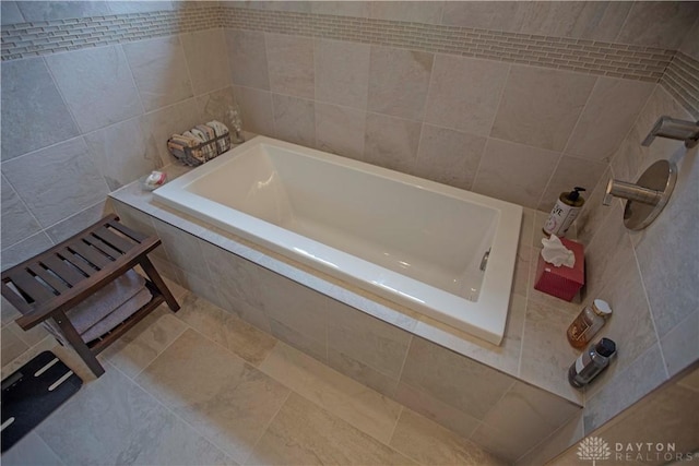 4560 James Madison Trl, Kettering, OH 45440 - bathroom with tile walls and a relaxing tiled tub