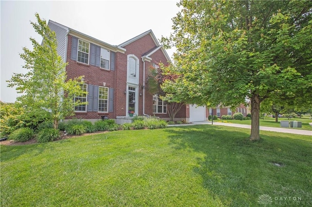 4560 James Madison Trl, Kettering, OH 45440 - colonial-style house with brick siding, a front yard, and a garage