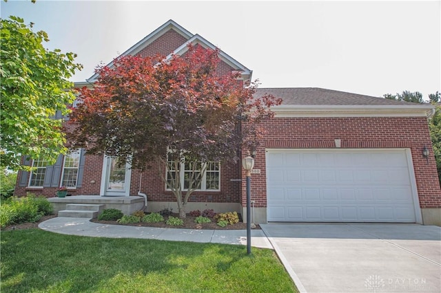 4560 James Madison Trl, Kettering, OH 45440 - view of front of house with brick siding, driveway, a garage, and a front yard