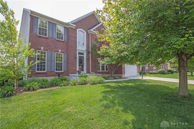 4560 James Madison Trl, Kettering, OH 45440 - view of front of house with brick siding, a front yard, a garage, and concrete driveway