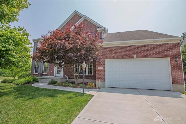 4560 James Madison Trl, Kettering, OH 45440 - view of front facade featuring brick siding, driveway, a front yard, and a garage