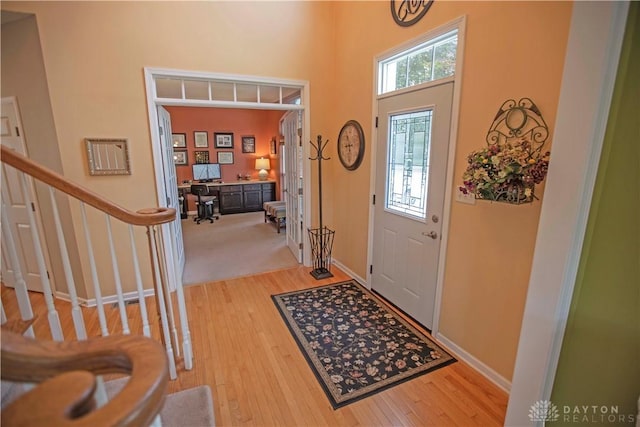 4560 James Madison Trl, Kettering, OH 45440 - entrance foyer featuring light wood-type flooring, stairway, a towering ceiling, and baseboards