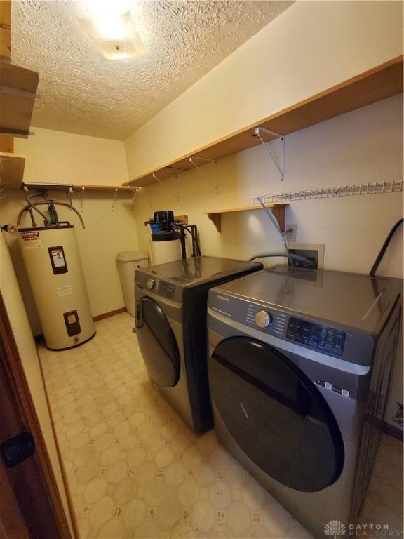 1261 Dusty Ln, West Alexandria, OH 45381 - washroom featuring water heater, independent washer and dryer, light flooring, and a textured ceiling