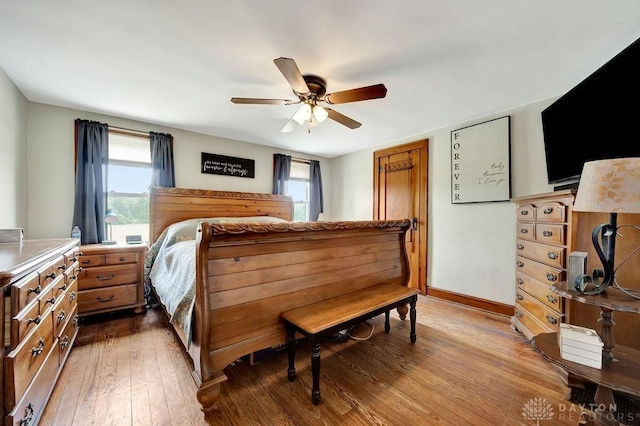 4975 Hamilton Eaton Rd, Hamilton, OH 45013 - bedroom featuring multiple windows, wood-type flooring, baseboards, and a ceiling fan