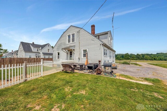 4975 Hamilton Eaton Rd, Hamilton, OH 45013 - back of house featuring a patio area and a chimney