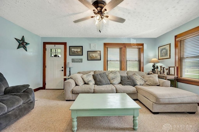 4975 Hamilton Eaton Rd, Hamilton, OH 45013 - living area featuring ceiling fan, healthy amount of natural light, a textured ceiling, light carpet, and baseboards