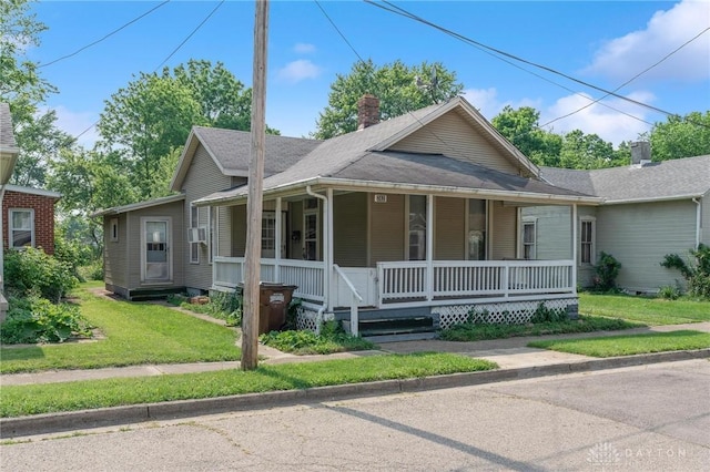 282 S W St, Xenia, OH 45385 - view of front of house featuring a porch, a chimney, a front lawn, and a shingled roof