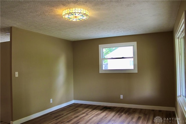 5317 Plainfield Rd, Dayton, OH 45432 - empty room with a textured ceiling, dark wood finished floors, and baseboards
