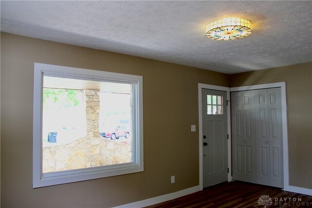 5317 Plainfield Rd, Dayton, OH 45432 - foyer with dark wood-style flooring, baseboards, a textured ceiling, and healthy amount of natural light