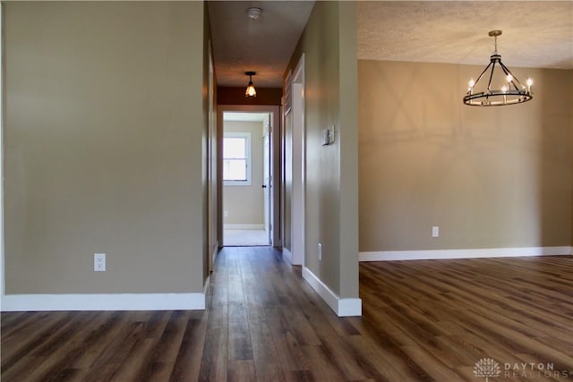 5317 Plainfield Rd, Dayton, OH 45432 - hall featuring a chandelier, dark wood finished floors, and baseboards