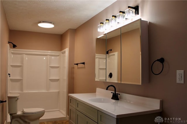 5317 Plainfield Rd, Dayton, OH 45432 - bathroom featuring a shower, vanity, toilet, and a textured ceiling