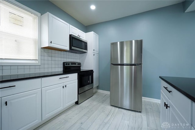 3409 E 5th St, Dayton, OH 45403 - kitchen featuring stainless steel appliances, dark countertops, backsplash, baseboards, and recessed lighting
