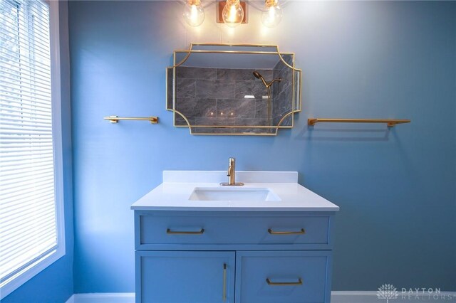 3409 E 5th St, Dayton, OH 45403 - bathroom featuring plenty of natural light, a tile shower, vanity, and baseboards