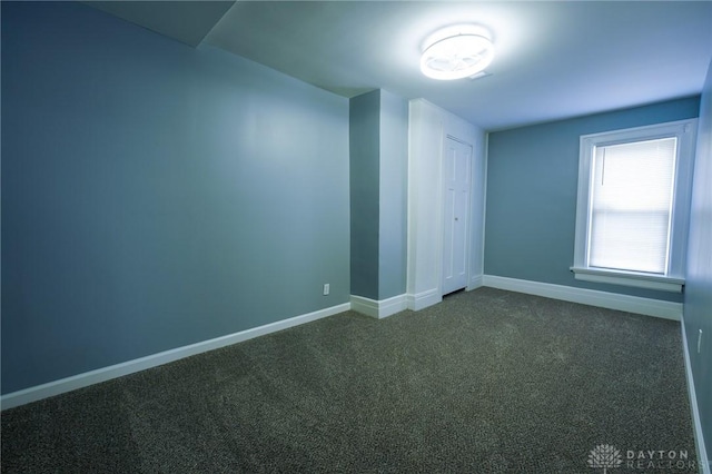 3409 E 5th St, Dayton, OH 45403 - unfurnished bedroom featuring dark carpet, baseboards, and a closet