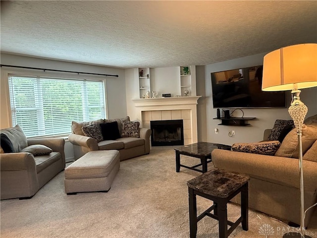1529 Creekside Rd, Amelia, OH 45102 - living room featuring a tile fireplace, light colored carpet, built in features, and a textured ceiling
