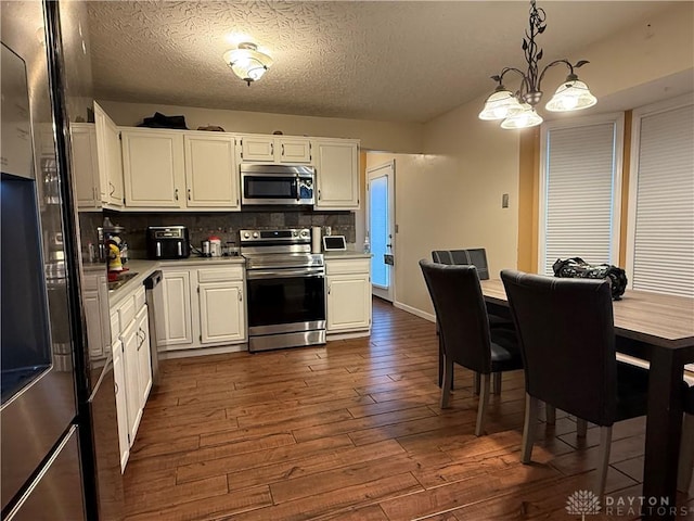 1529 Creekside Rd, Amelia, OH 45102 - kitchen with stainless steel appliances, dark wood-type flooring, white cabinets, light countertops, and a textured ceiling