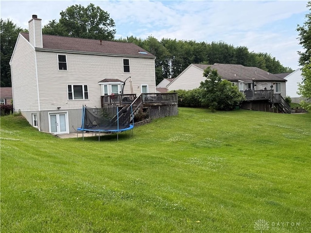1529 Creekside Rd, Amelia, OH 45102 - back of property with a wooden deck, stairway, a chimney, and a yard