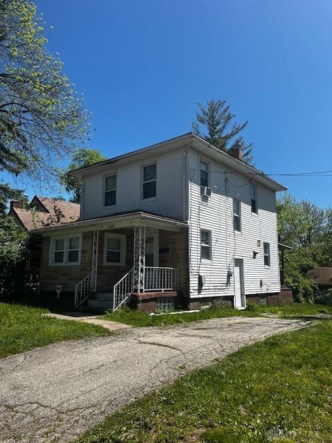 2218 Rugby Rd, Dayton, OH 45406 - rear view of property featuring covered porch and a lawn