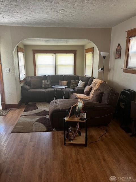 2218 Rugby Rd, Dayton, OH 45406 - living area with arched walkways, wood finished floors, a textured ceiling, and baseboards