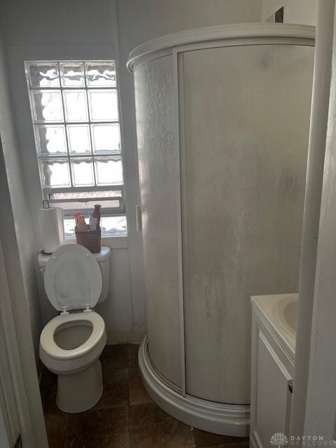 2218 Rugby Rd, Dayton, OH 45406 - bathroom featuring a shower stall, vanity, tile patterned floors, and toilet