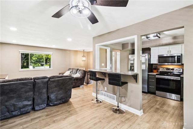 2706 Coldsprings Dr, Beavercreek, OH 45434 - living room with light wood-type flooring, ceiling fan, and recessed lighting
