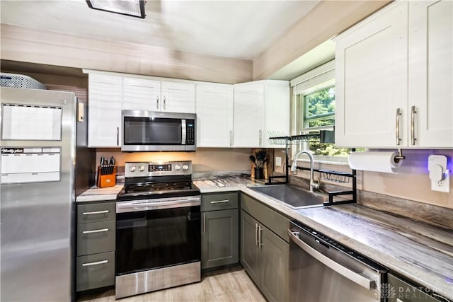 2706 Coldsprings Dr, Beavercreek, OH 45434 - kitchen with stainless steel appliances, white cabinetry, gray cabinets, light wood-style floors, and light countertops
