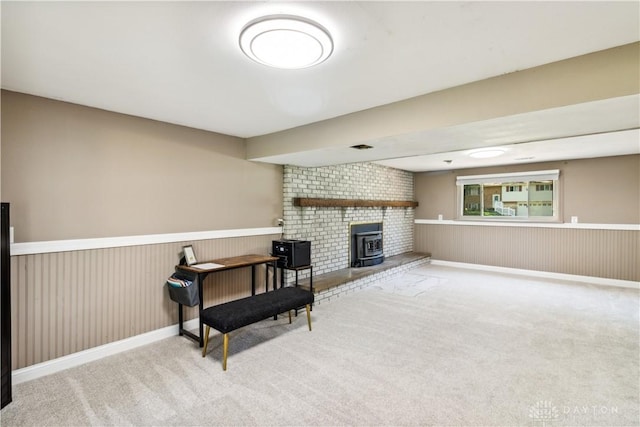 2706 Coldsprings Dr, Beavercreek, OH 45434 - living area with carpet, a wood stove, and a wainscoted wall