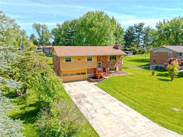 2706 Coldsprings Dr, Beavercreek, OH 45434 - split foyer home featuring a chimney, brick siding, driveway, a garage, and view of scattered trees