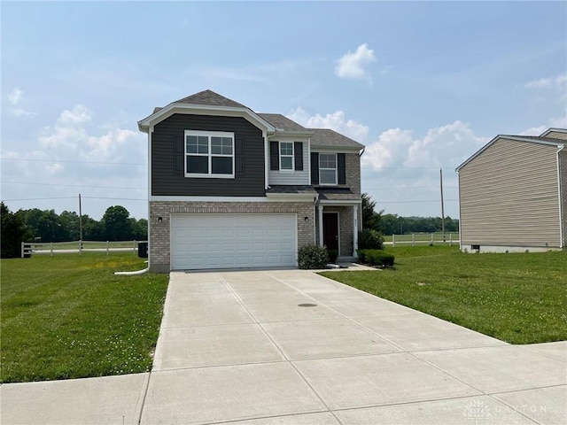 821 Prescot Cir, Trenton, OH 45067 - view of front of property with a garage, brick siding, driveway, and a front lawn