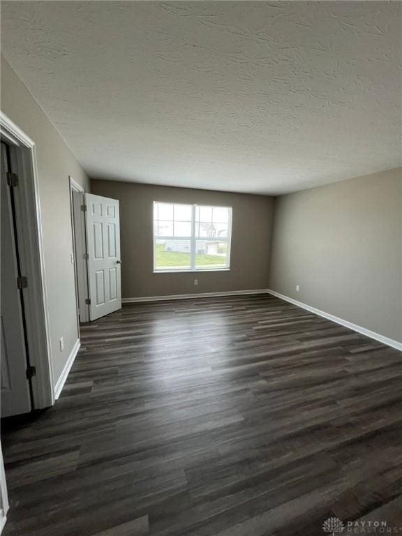 821 Prescot Cir, Trenton, OH 45067 - unfurnished bedroom with dark wood finished floors and a textured ceiling