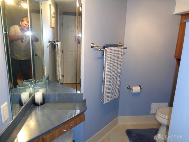 4502 Central Ave, Middletown, OH 45044 - bathroom with toilet, tile patterned flooring, baseboards, vanity, and a shower with shower door