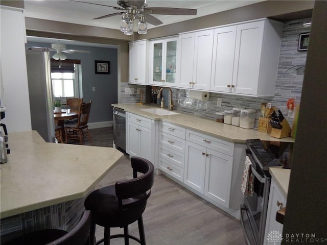 4502 Central Ave, Middletown, OH 45044 - kitchen with range, a sink, ceiling fan, tasteful backsplash, and ornamental molding