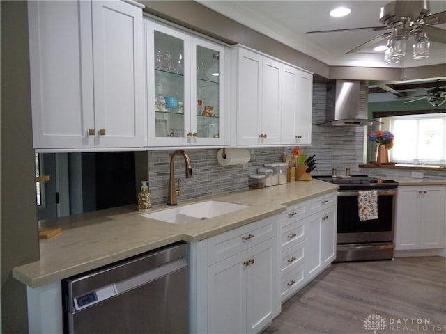 4502 Central Ave, Middletown, OH 45044 - kitchen with stainless steel appliances, wall chimney exhaust hood, a sink, crown molding, and white cabinetry