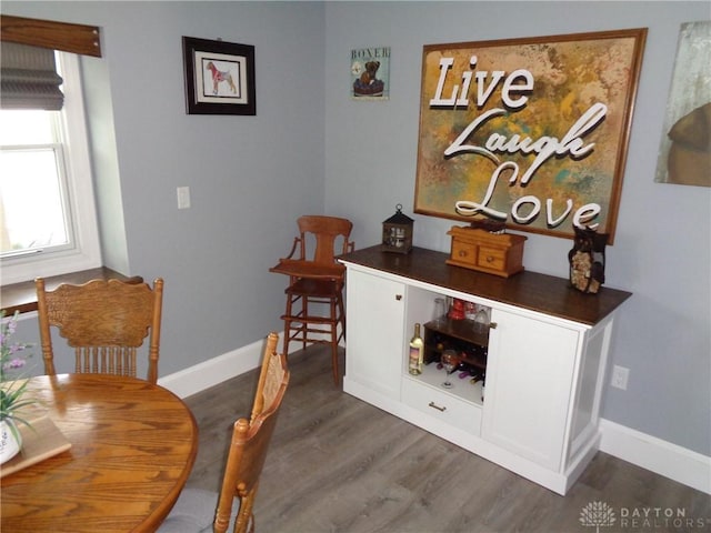 4502 Central Ave, Middletown, OH 45044 - dining room with dark wood-type flooring, a bar, and baseboards