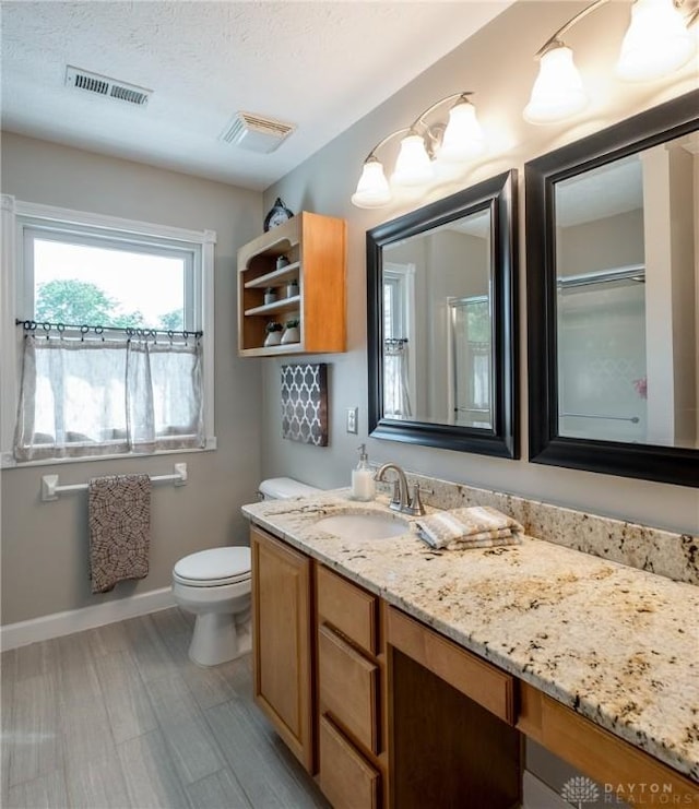 1199 Whitetail Dr, Fairborn, OH 45324 - full bathroom featuring vanity, toilet, baseboards, and a textured ceiling