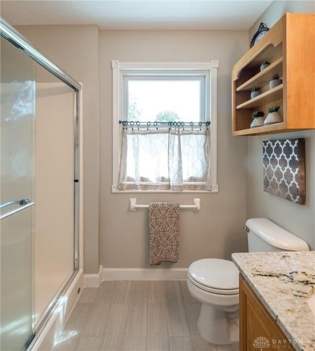 1199 Whitetail Dr, Fairborn, OH 45324 - bathroom featuring an enclosed shower, toilet, baseboards, and vanity